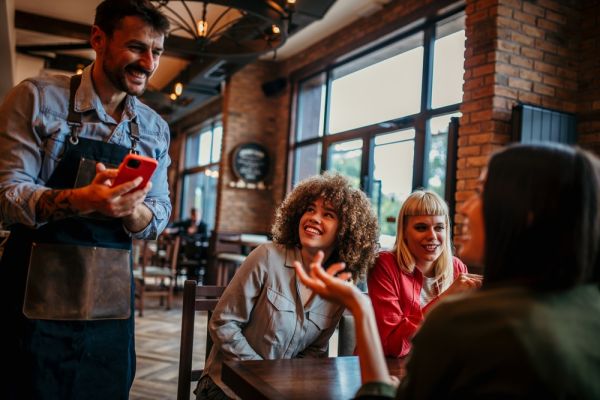 Group of friends taking order for a Houston Steak Night